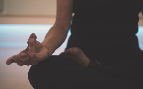 Person with hands gently clasped, representing natural healing and calm mindfulness