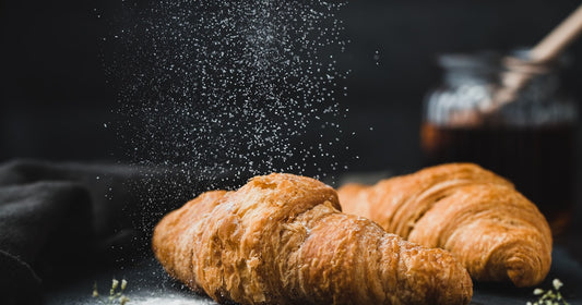 A tempting spread of bread, pasta, and sugary foods — illustrating the carb cravings that hypnotherapy can help overcome