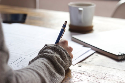 Person sitting at a clean desk ready to work, symbolising focus and overcoming procrastination with hypnotherapy