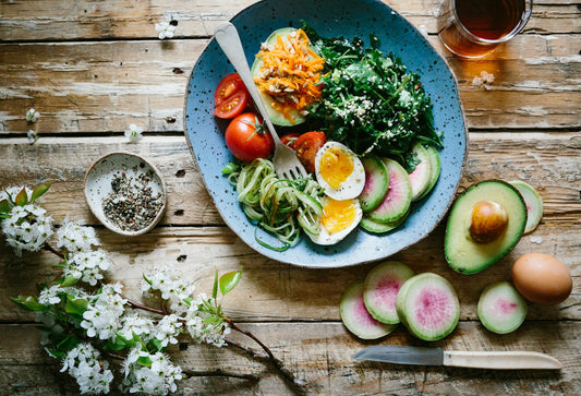 Healthy whole foods on a wooden table representing mindful eating and reduced food cravings