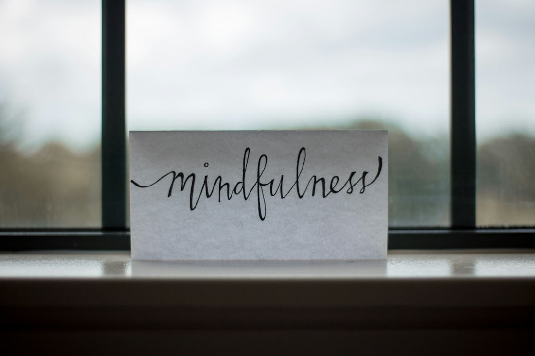 Person sitting quietly in soft natural light, eyes closed, finding peace and calm — representing hypnotherapy for rumination and letting go of the past