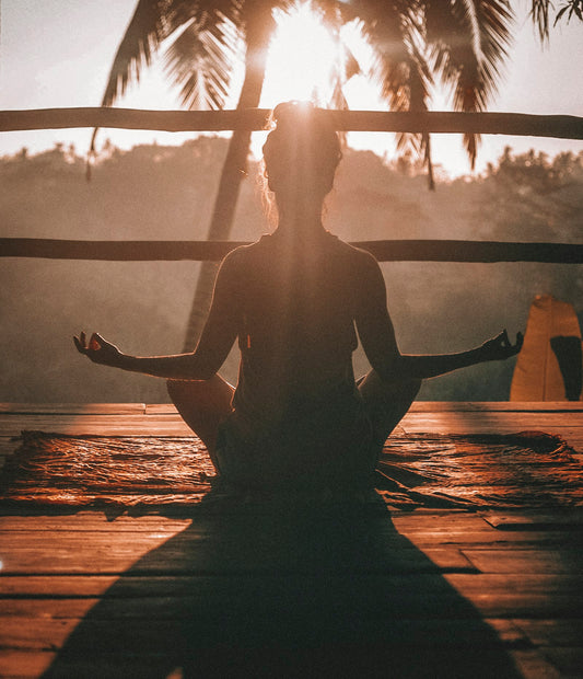 Woman resting with eyes closed during guided relaxation session