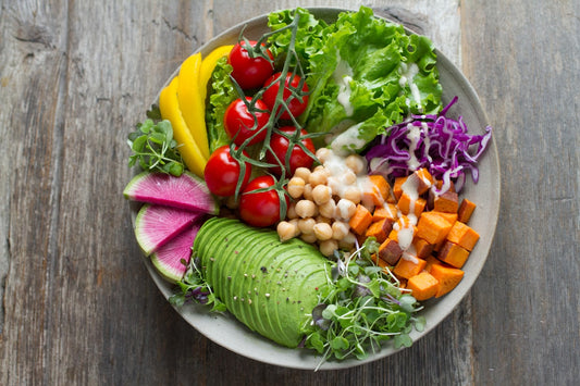 A healthy, balanced meal on a table beside a glass of water, representing mindful eating and weight loss choices