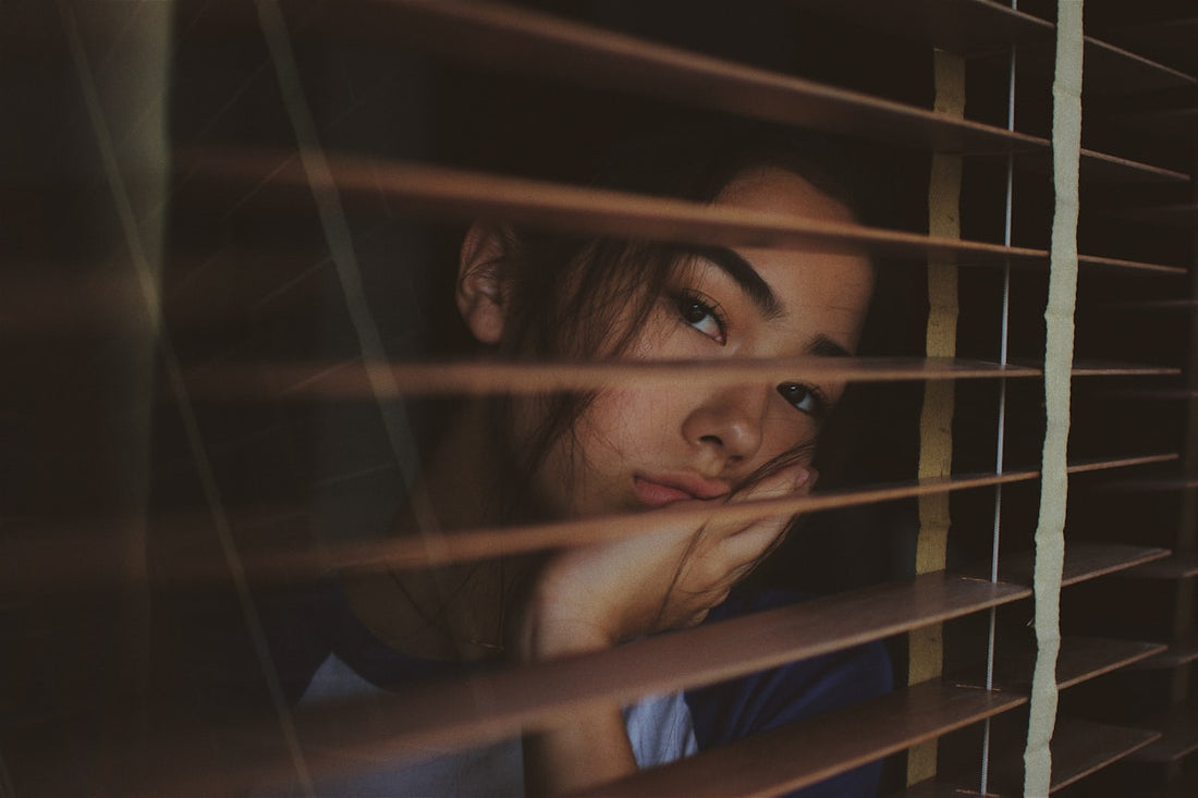 Person lying awake at night unable to sleep due to restless legs syndrome