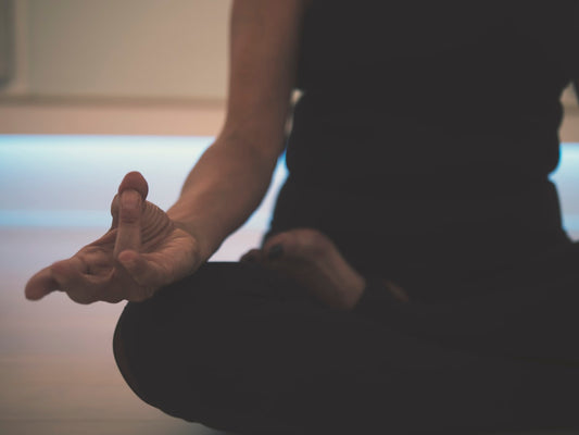 Person with hands gently clasped, representing natural healing and calm mindfulness