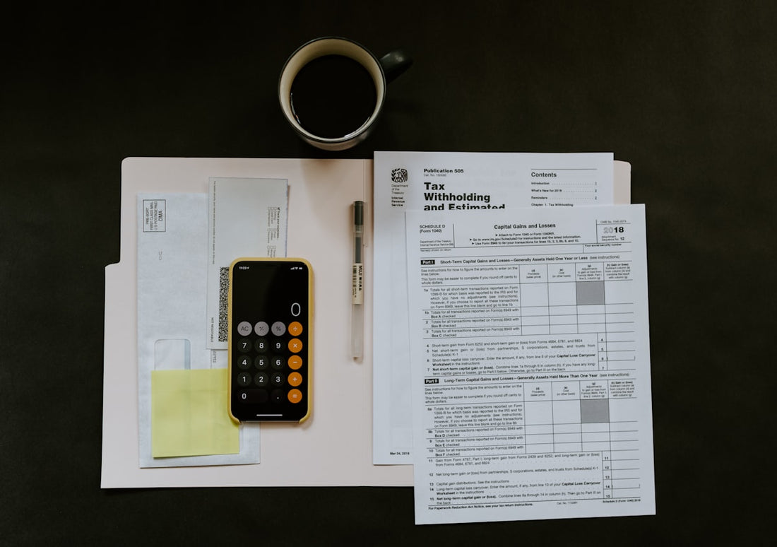 Person sitting calmly at a desk, reflecting on financial documents — illustrating the peace that comes from addressing financial anxiety with hypnotherapy